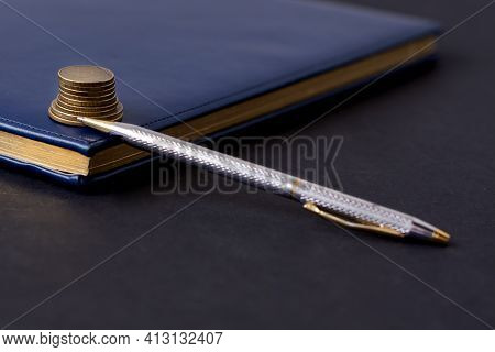 Blue Diary And Pen On A Black Background. Planning. Business Concept