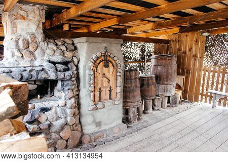Old Slavic Village Street Cooking Stove With Stack Of Firewood Nearby