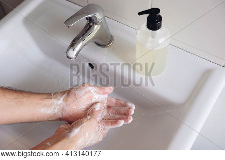 Washing Hands Concept. Man Cleaning His Hands Using Liquid Disinfectant Soap And Water In Bathroom, 