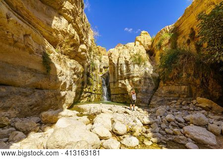 Ein Gedi, Israel - March 13, 2021: View Of The Hidden Waterfall Along The Arugot Stream, With A Visi