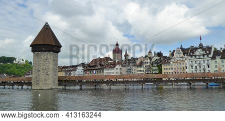 Lucerne, Switzerland - May 20th 2017: Historic Bridge And Facade At The Water