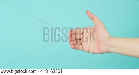 Empty Hand Holding Or Catch Nothing Guesture On Green And Blue Or Mint Background.