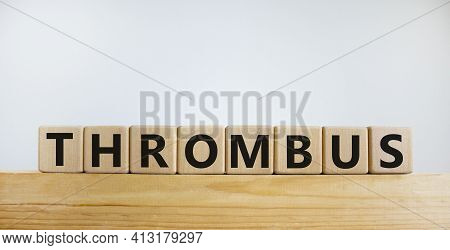 Medical And And Thrombus Symbol. Wooden Cubes With The Word 'thrombus'. Beautiful White Background. 