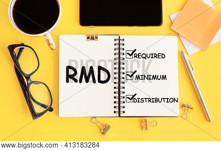 Rmd - Required Minimum Distributions, Text On Notepad And Office Accessories On Yellow Desk.
