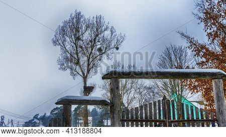 Snowy Old Garden Gate In Village Courtyyard. Snowy Wooden Gate After A Blizzard. Winter Background.