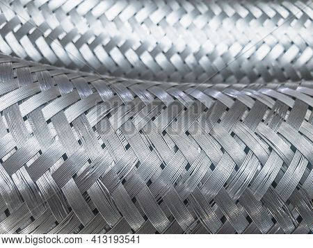 Long Metal Flexible Compensator Pipes Metal Texture Closeup. Selective Focus. White Metal Industrial