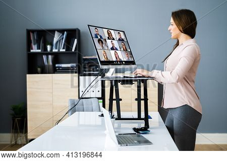 Adjustable Height Desk Stand In Office Using Computer