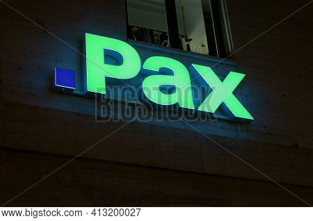 Lugano, Ticino, Switzerland - 14th January 2021 : Luminous Pax Assurance Sign Hanging On A Building 