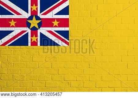 Flag Of Niue. Brick Wall Texture Of The Flag Of Niue.