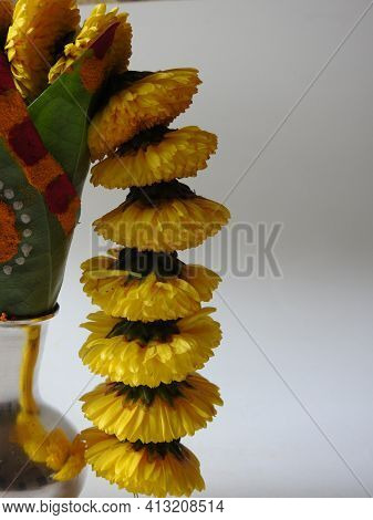 Closeup Of Silver Kalash Decorated With Chrysanthemum Flower, Leaf, Coconut, Kumkum And Turmeric Wit