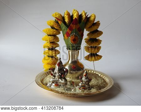Closeup Of Silver Kalash Decorated With Chrysanthemum Flower, Leaf, Coconut, Kumkum And Turmeric Wit