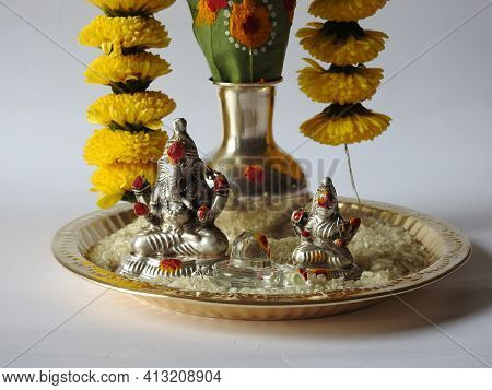 Closeup Of Silver Kalash Decorated With Chrysanthemum Flower, Leaf, Coconut, Kumkum And Turmeric Wit
