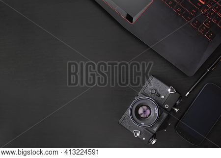 Black Smartphone, Keyboard, Camera On A Black Background. Business Matters. Discreet Photography. Fr