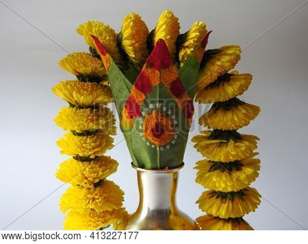 Closeup Of Silver Kalash Decorated With Chrysanthemum Flower, Leaf, Coconut, Kumkum And Turmeric Wit