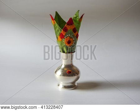 Closeup Of Silver Kalash Decorated With Chrysanthemum Flower, Leaf, Coconut, Kumkum And Turmeric Wit