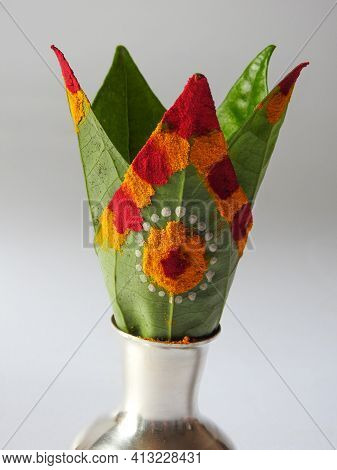 Closeup Of Silver Kalash Decorated With Chrysanthemum Flower, Leaf, Coconut, Kumkum And Turmeric Wit
