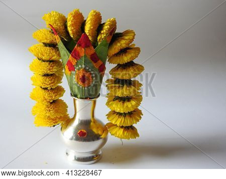 Closeup Of Silver Kalash Decorated With Chrysanthemum Flower, Leaf, Coconut, Kumkum And Turmeric Wit