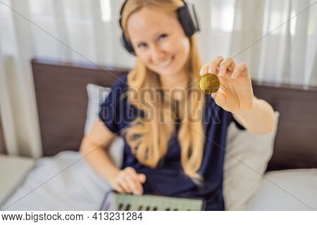 Young Woman, A Digital Artist, Dj Creates Digital Art On A Tablet At Home And Shows A Coin With The 