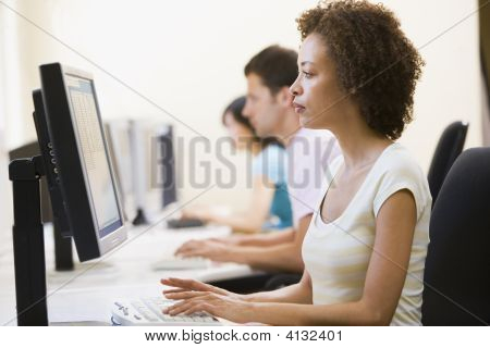 Three People In Computer Room Typing