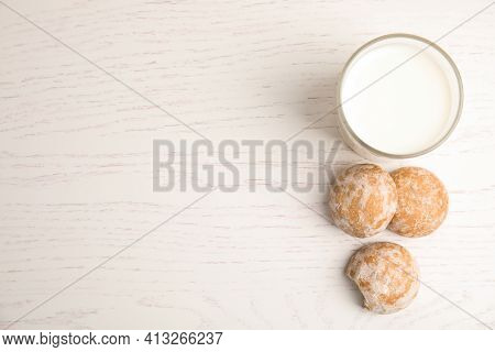 Tasty Homemade Gingerbread Cookies And Glass Of Milk On White Wooden Table, Flat Lay. Space For Text