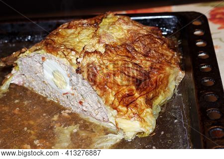 Meat Roll With Eggs In Savoy Cabbage Leaves. Last Half, On Baking Sheet, In Its Own Juice. On Cut Yo