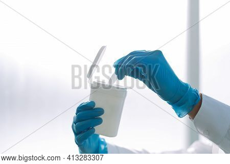 Image Of A Doctor Taking A Wet Wipe Out Of A Container .