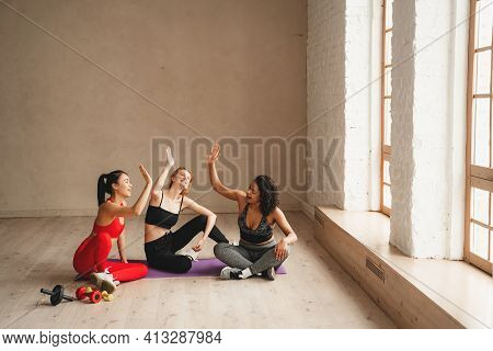 Fit Athletic Women Happy About Healthy Lifestyle. Beautiful Women Working Out In Gym Together. Inten