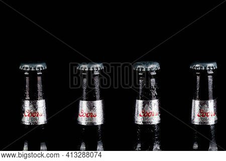 Sandhurst, United Kingdom, 18th March 2021:- Four Bottles Of Coors Light Isoalted On A Black Backgro