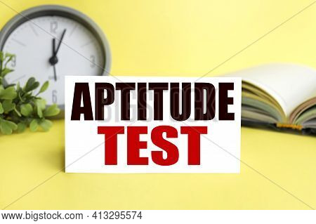 Aptitude Test. Text On White Paper On A Yellow Background