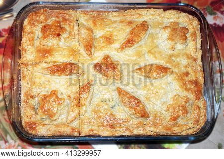 Homemade Meat Pie With Golden Crust, Decorated With Ornament Of Dough, Cools In Glass Baking Dish, I