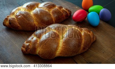 Easter Eggs And Tsoureki Braid, Greek Easter Sweet Bread, On Wooden Background