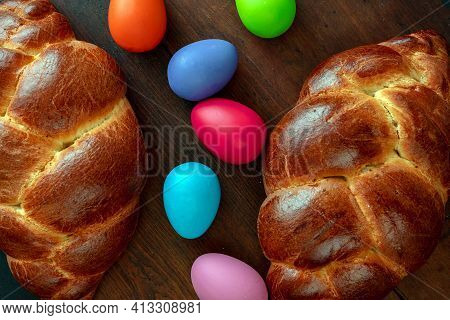 Easter Eggs And Tsoureki Braid, Greek Easter Sweet Bread, On Wooden Background