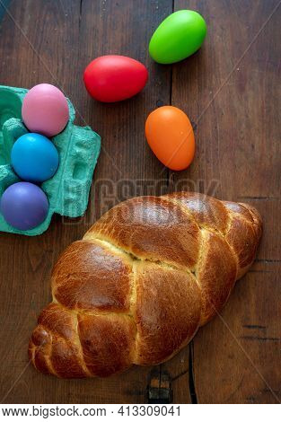Easter Eggs And Tsoureki Braid, Greek Easter Sweet Bread, On Wooden Background