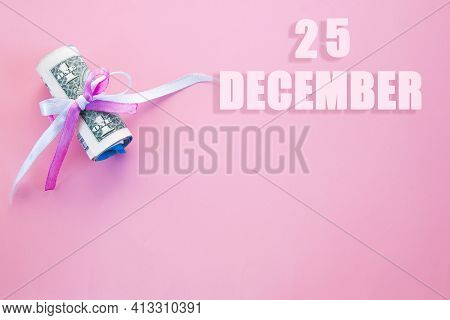 Calendar Date On Pink Background With Rolled Up Dollar Bills Pinned By Pink And Blue Ribbon With Cop