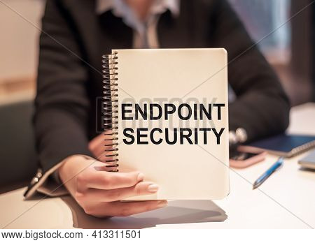 Business Woman Holds A Notebook With The Text Endpoint Security.
