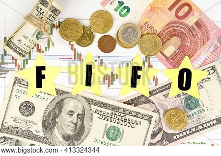 Finance And Economics Concept. Among The Charts And Money Are Asterisks With The Inscription -fifo