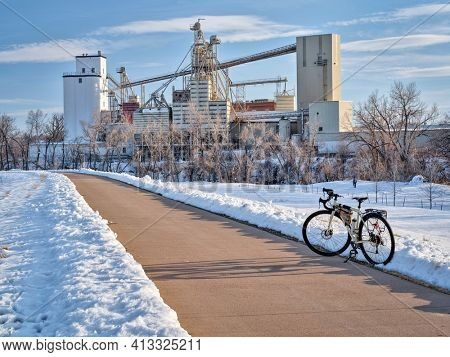 touring bike on a bike trail along the Poudre RIver in Fort Collins, Colorado, winter scenery. recreation and commuting concept