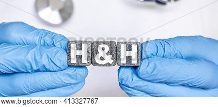 Hh Hemoglobin And Hematocrit - Word From Stone Blocks With Letters Holding By A Doctors Hands In Med