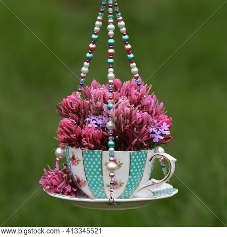 Pink And Purple Wildflowers In A Teal Blue Teacup Vase