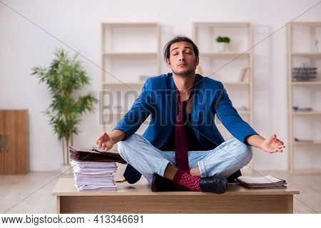 Young male employee in oversleeping concept