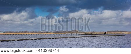 Panorama Of The Dramatic Skies Over The Lake In Roegwold, Netherlands