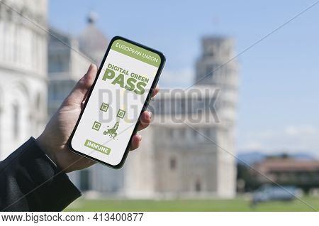 Digital Green Pass Concept: Woman Hold A Smartphone In Front Of The Pisa Leaning Tower That Show An 