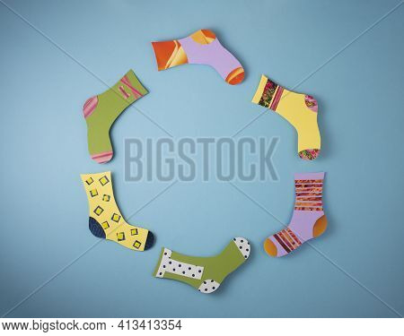 World Down Syndrome Day Concept. Different Socks Made From Paper On Blue Background. Flat Lay, Top V