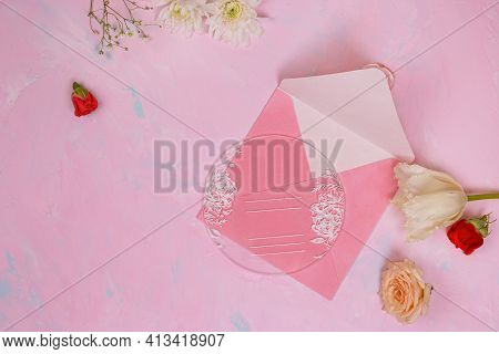 Opened Velvet Pink Gift Certificate With Flowers On Pink Stone Background. Present. Celebration. Top
