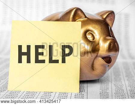 Golden Pig Saving Bank And Yellow Paper For Text Help On Wooden Table With Many Page Financial State