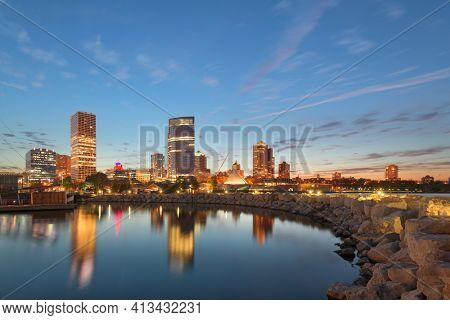 Milwaukee, Wisconsin, USA downtown city skyline on Lake Michigan at twilight.