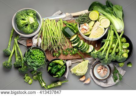 Set Of Various Green Raw Healthy Vegetables On Wooden Board