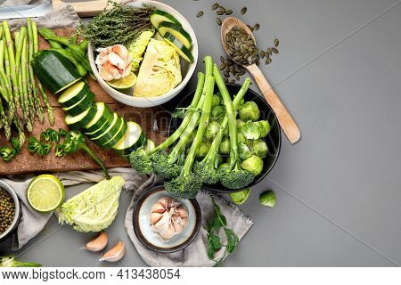 Set Of Various Green Raw Healthy Vegetables On Wooden Board