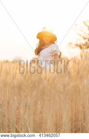 Happy Young Beautiful Woman Wearing Black Hat And White Dress Enjoying Herself Walking In The Golden