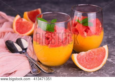 Cream Kurd From Grafruit In Glasses On A Gray Background. Close-up.